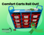 Green background, Title Comfort Carts Roll Out. Photo of a blue and red rolling cart with multiple drawers. Green mental health ribbon, library logo