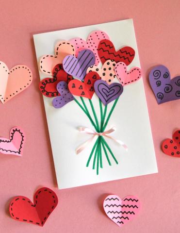 Valentine Day card with raised up multi color hearts in a boquet on a pink background