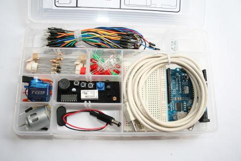 An image of a kit made from clear plastic, which includes cords, lights, circuits, and more.