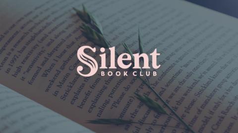 Pale pink text reading "Silent Book Club," featuring a piece of greenery on an open book page