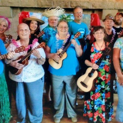 Image of Ukulele Band members holding ukulele's while smiling.