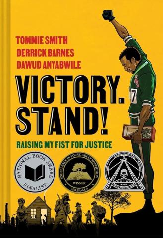 The cover of the graphic novel Victory, Stand! which features an illustration of an Olympic medalist raising his fist, standing against a yellow background.