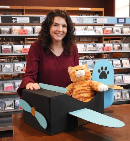 Library staffer Karrah with Cardboard Cat Plane she made from boxes