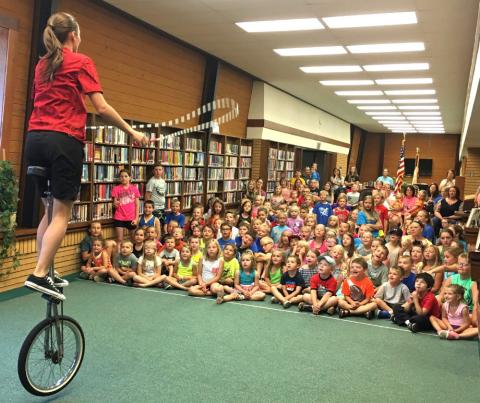 Christa Hanson on unicycle at large public event