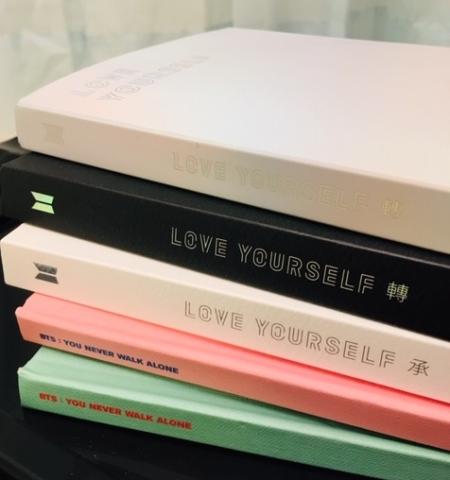Stack of various BTS albums.