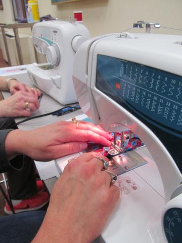 Close up photo of hands at sewing machines at Rock Island Library