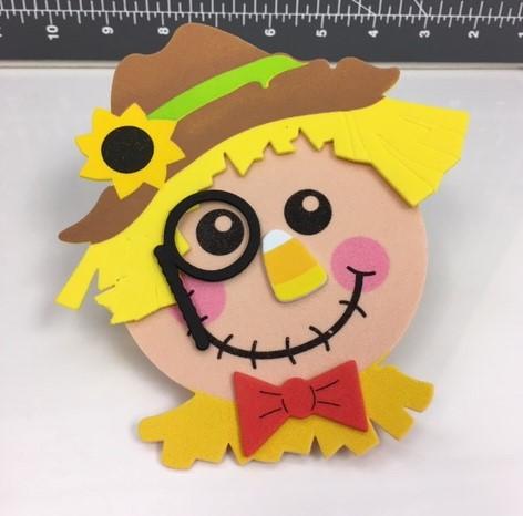foam craft scarecrow with sunflower hat, bowtie and eye monocal.