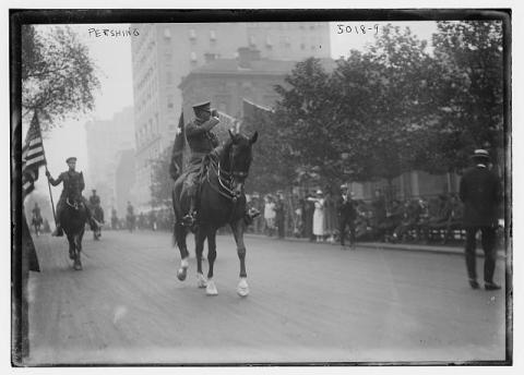 Photograph shows General John J. Pershing on horseback leading World War I veterans during a victory parade in New York City, September 10, 1919.