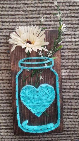 Photo of string art craft mason jar shape with heart 