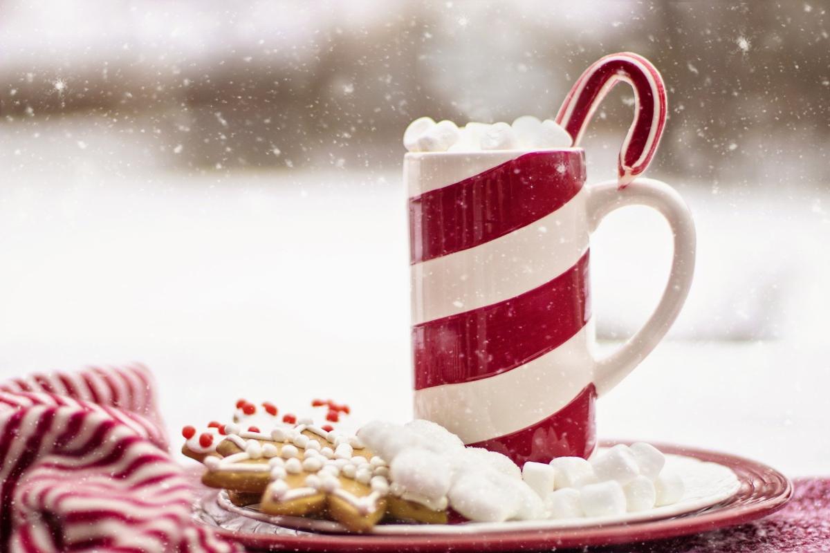 Steaming mug of cocoa in a candy-cane cup 