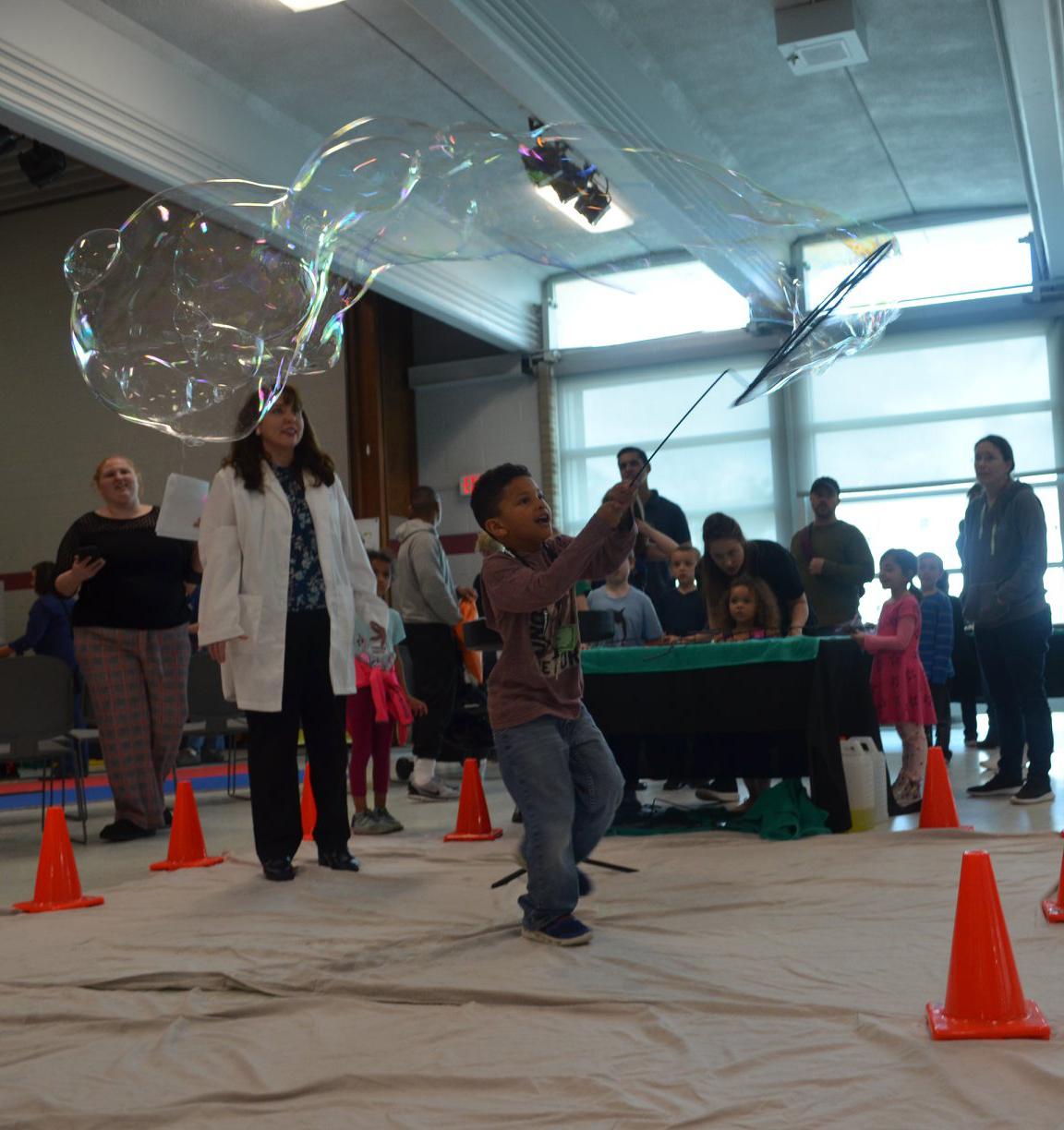 Absolute Science photo of a child using a large bubble wand at another event