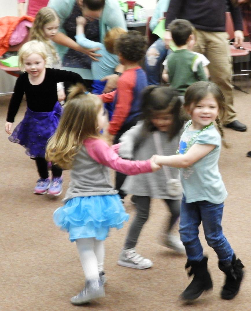 Library photo 2018 Hug-a-Book dance party three girls twirling in a circle
