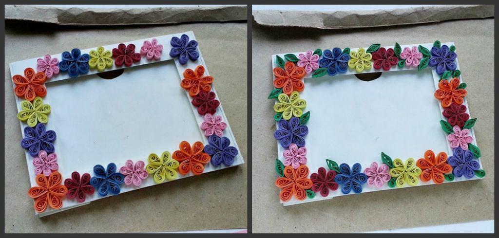 White cardstock picture frame adorned with paper flowers made out of magazine strips.