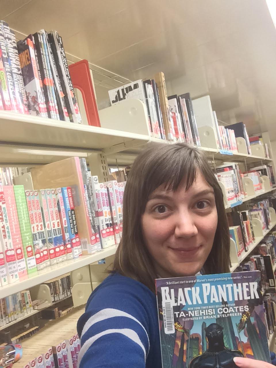 Emily the Young Adult Librarian holding a graphic novel