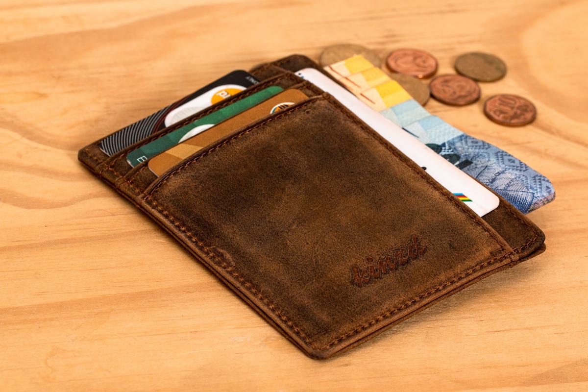 picture of wallet with cards and money spilling out 